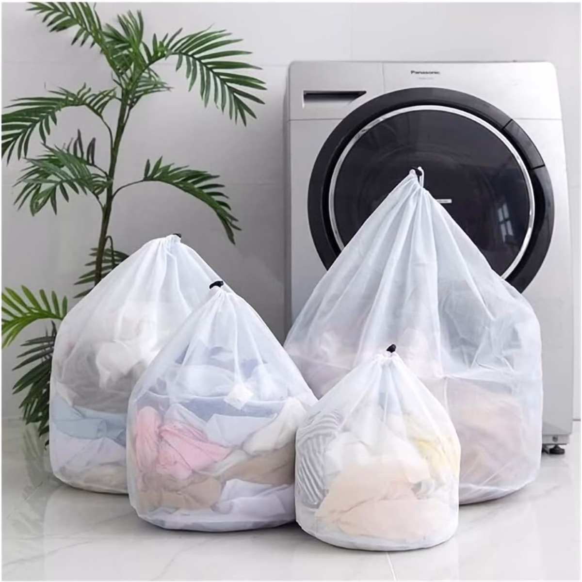 Five mesh bags for delicate clothes with drawstring closures, ideal for washing undergarments.