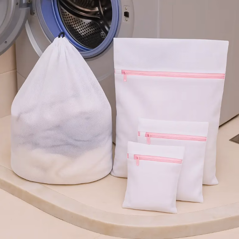 Drawstring and zipper heavy duty mesh laundry bags side by side on a counter