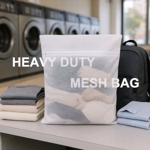 White heavy duty mesh bag on laundromat counter with clothes and backpack